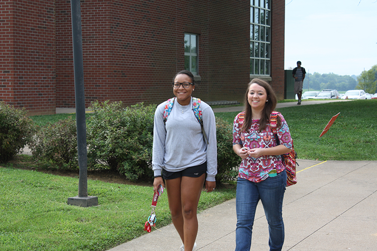 two girls walking on campus
