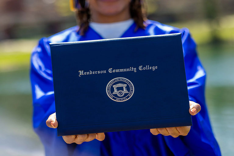graduate holding a diploma