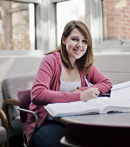 girl smiling at desk