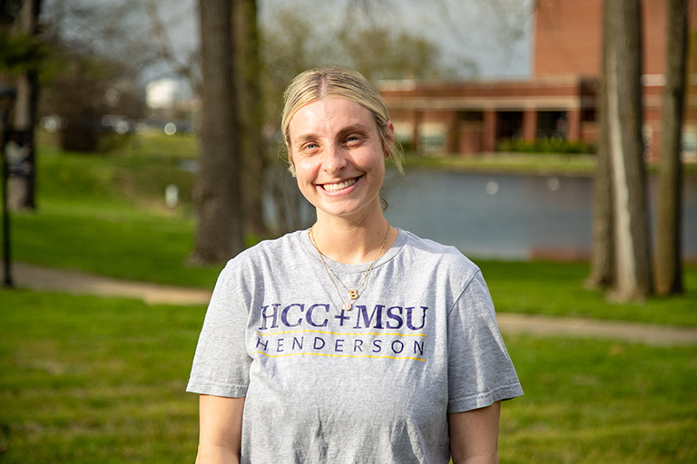 a lady standing outside in a HCC/MSU t shirt
