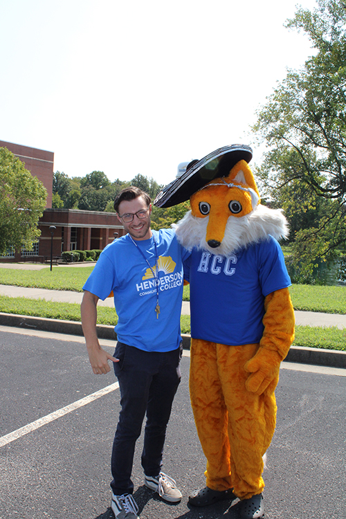 a man standing next to the Pathfinder mascot