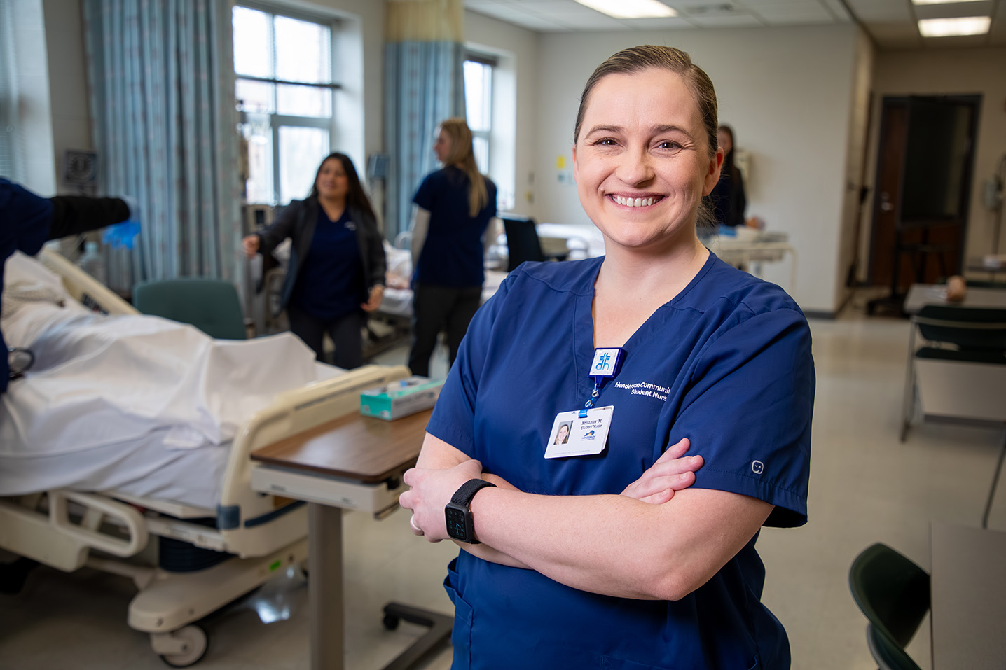 Woman in nursing scrubs looking at the camera smiling