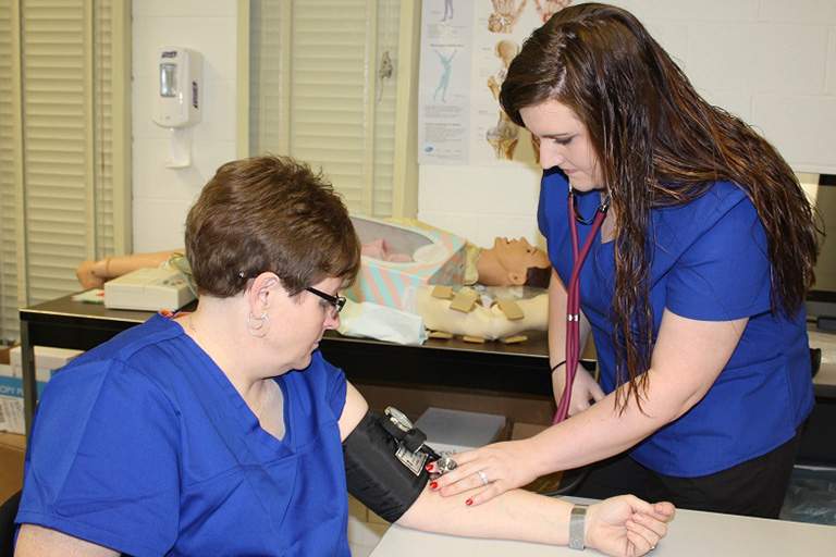 students practicing blood pressure skills