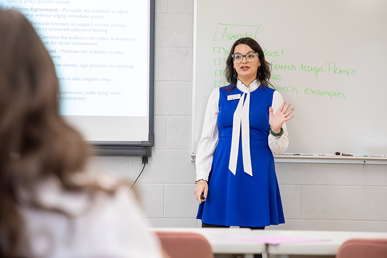 a female teacher lecturing the class