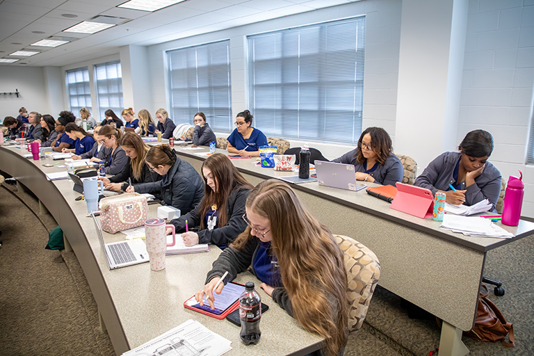 students sitting in a lecture hall classroom