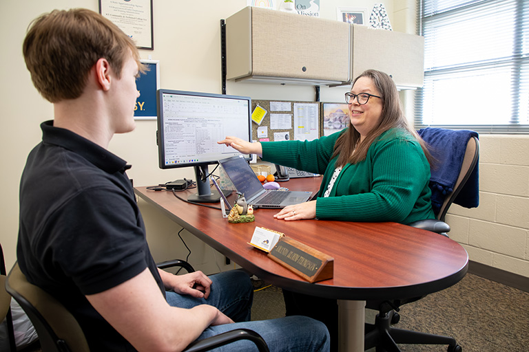 a student sitting in an advisor's office