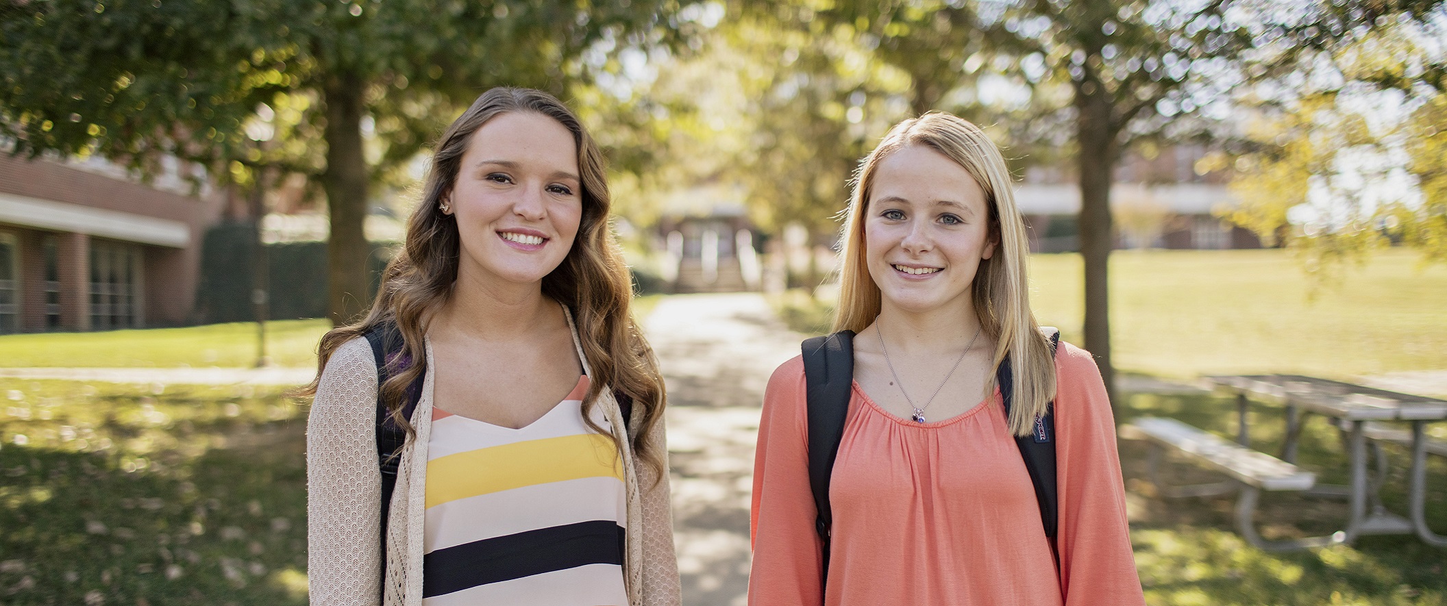 girl walking into campus building