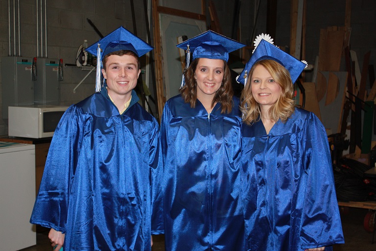 Three students in their caps and gowns