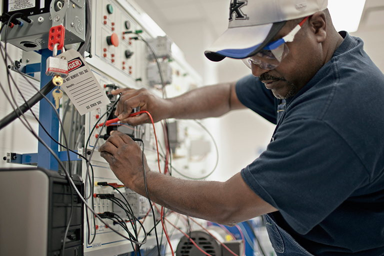 Man adjusting electrical wiring