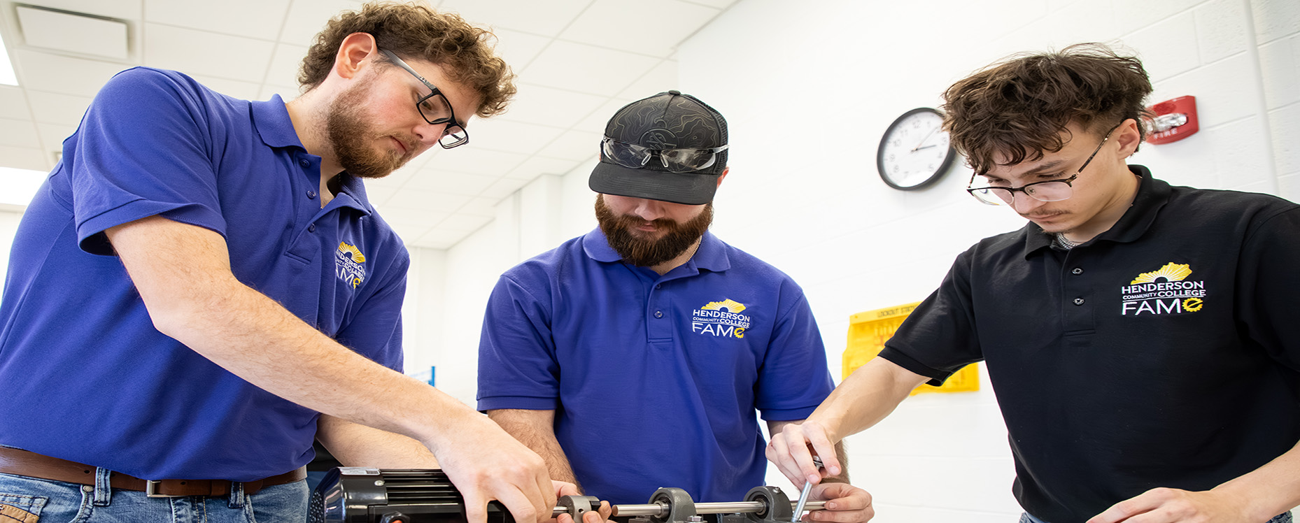 three industrial maintenance students working on equipment