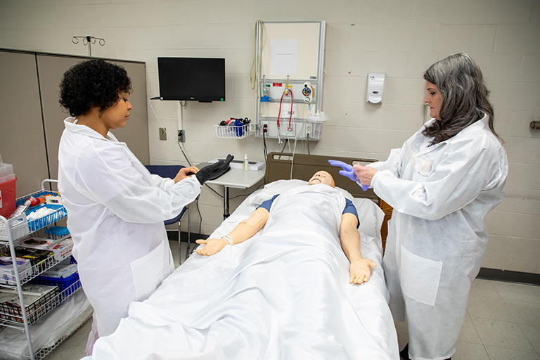 two medical lab technicians working in a practice lab