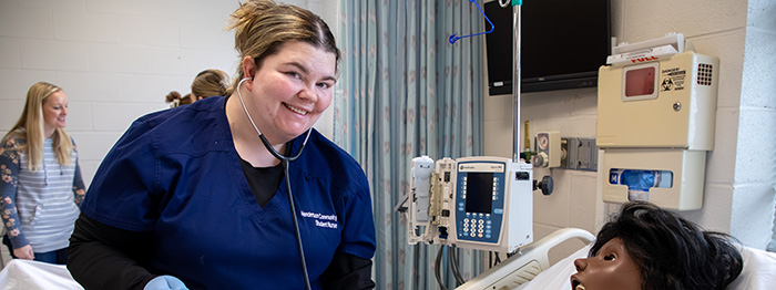 photo of a female nursing student using a stethoscope